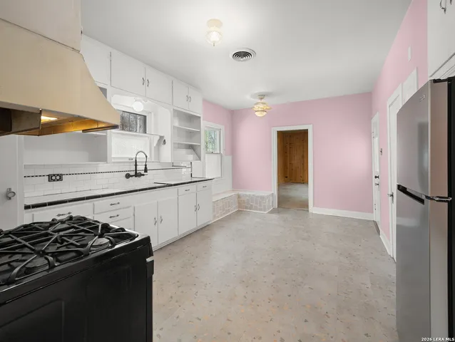 a kitchen with stainless steel appliances a sink a stove and a refrigerator