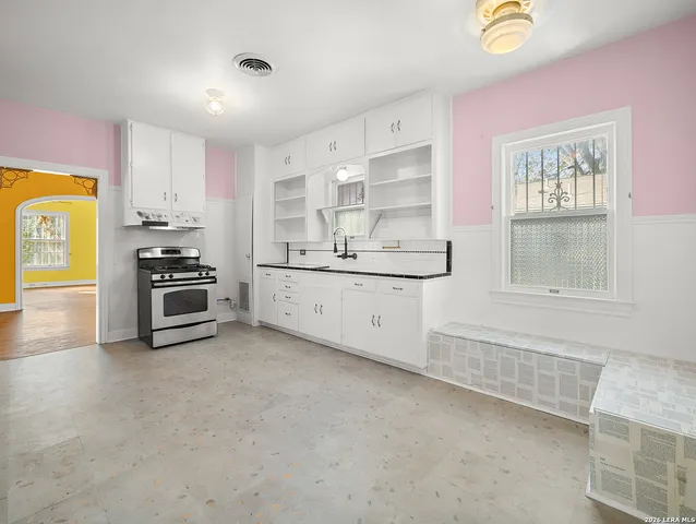 a kitchen with stainless steel appliances a stove a sink and a refrigerator