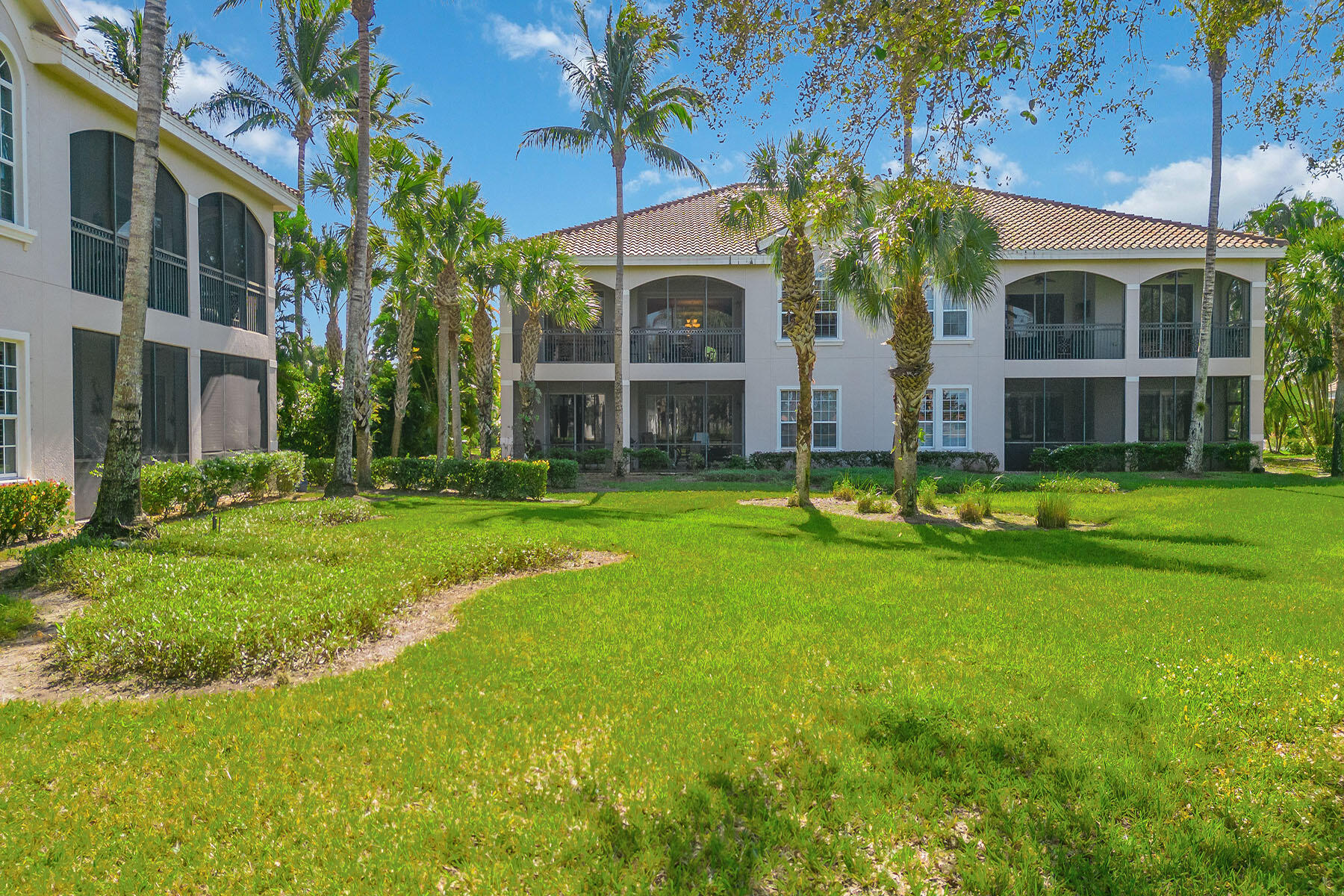 3189 Aviamar Circle, Unit 202 Naples, FL 34114 - Photo 27 of 50 a front view of house with yard and green space