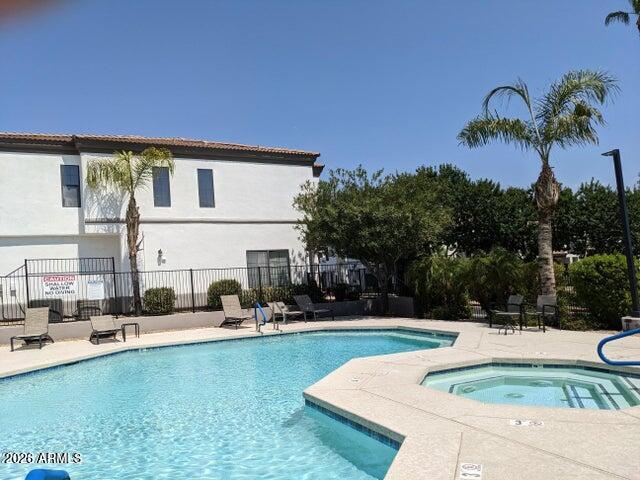 3150 East Beardsley Road, Unit 1045 Phoenix, AZ 85050 - Photo 21 of 23 a swimming pool with outdoor seating and yard