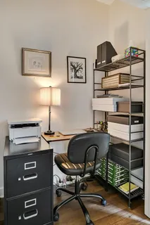 a view of a balcony with two chairs and wooden floor