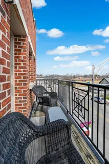 a bathroom with a granite countertop sink a toilet and a mirror
