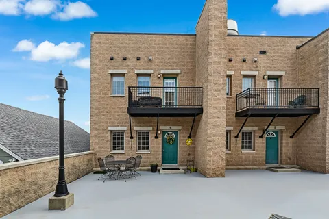 a view of a patio with table and chairs and potted plants