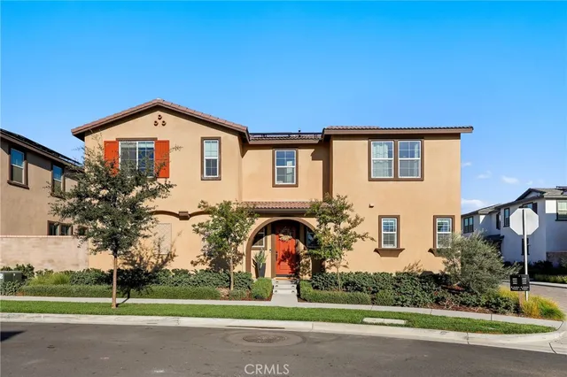 a front view of a house with a garden and plants