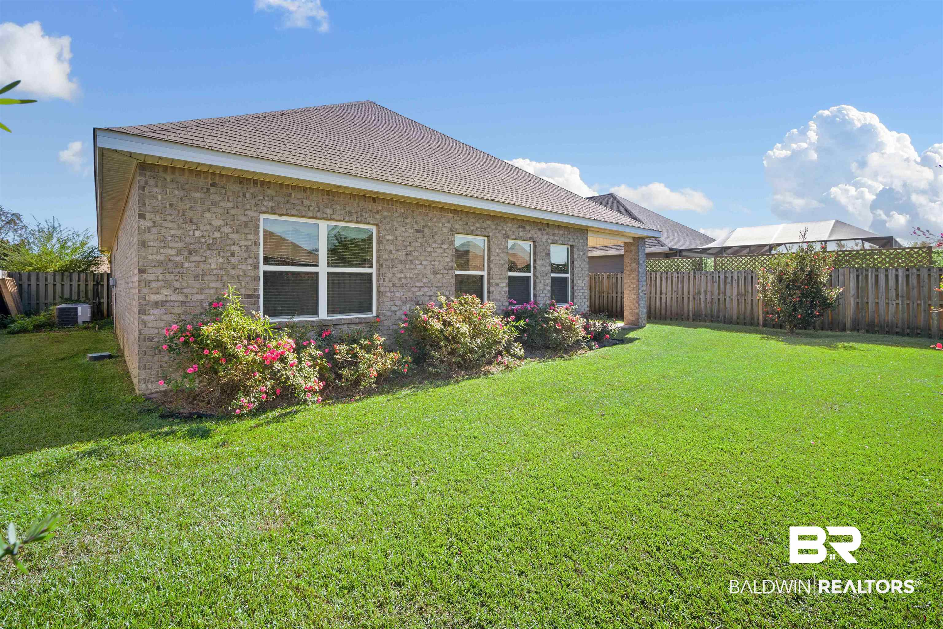 24479 Kipling Court Daphne, AL 36526 - Photo 24 of 41 Back of house featuring a fenced backyard, brick siding, and a shingled roof