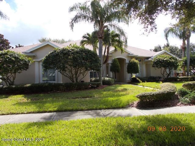 a view of a house with a swimming pool and a yard