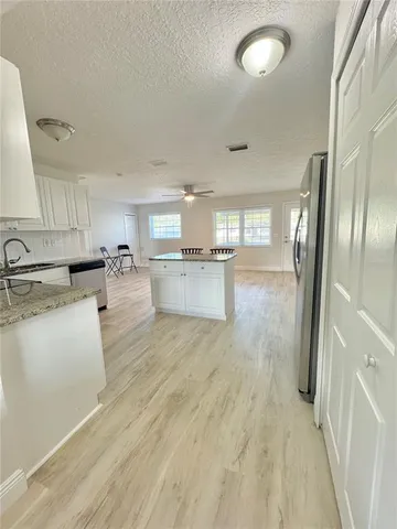 a kitchen with stainless steel appliances granite countertop a refrigerator a sink and a stove