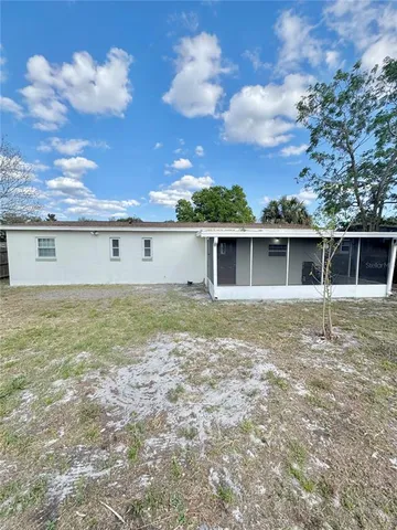 a view of a house with a backyard