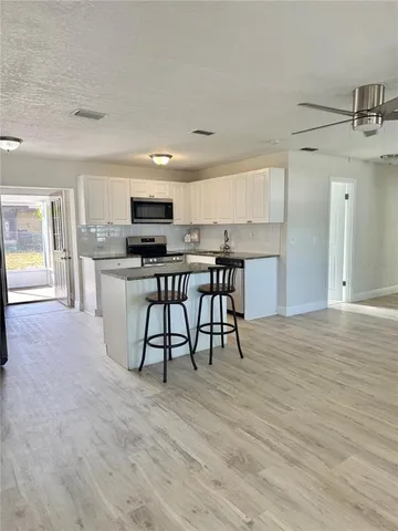 a view of a kitchen and dining room