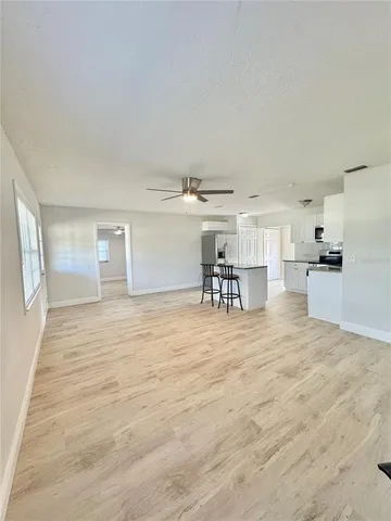 a view of livingroom with furniture and a kitchen