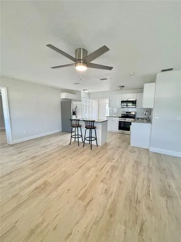a view of kitchen with furniture and wooden floor