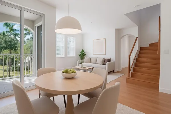 a view of a dining room with furniture and wooden floor