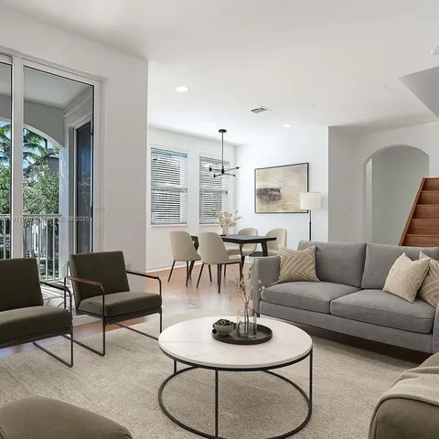 a living room with furniture a rug and a large window