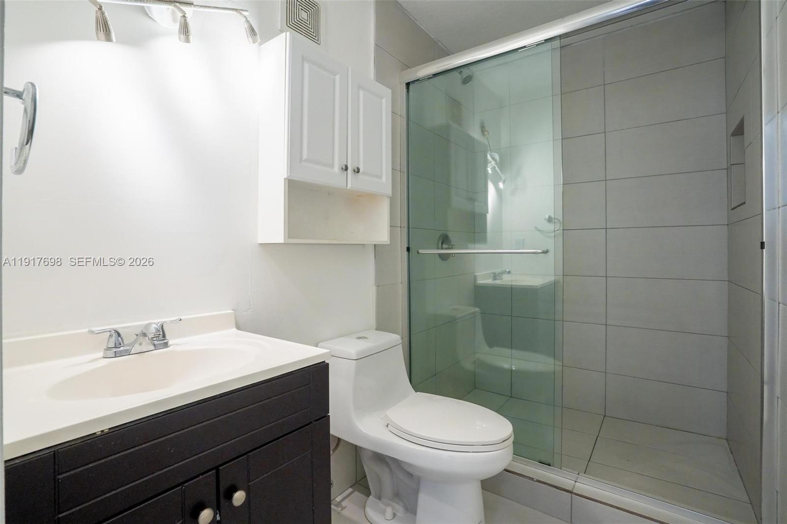 4371 Southwest 160th Avenue, Unit 211 Miramar, FL 33027 - Photo 13 of 31 a bathroom with a sink toilet and shower
