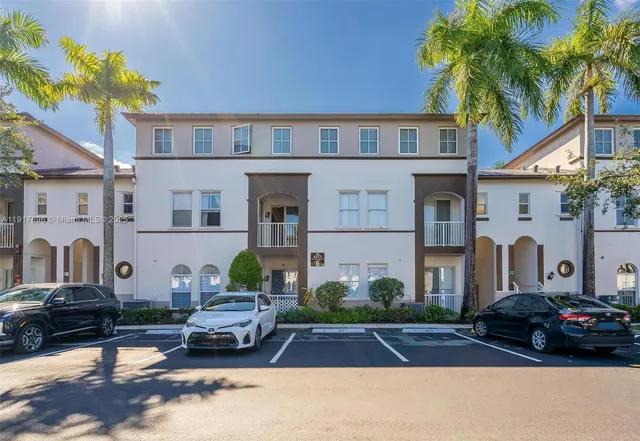 a view of a car park in front of a house