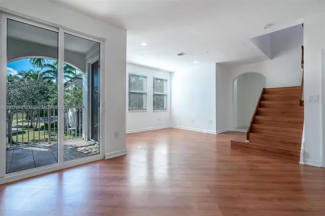 a view of an entryway with wooden floor and door