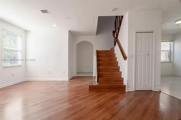 a view of an entryway with wooden floor and staircase