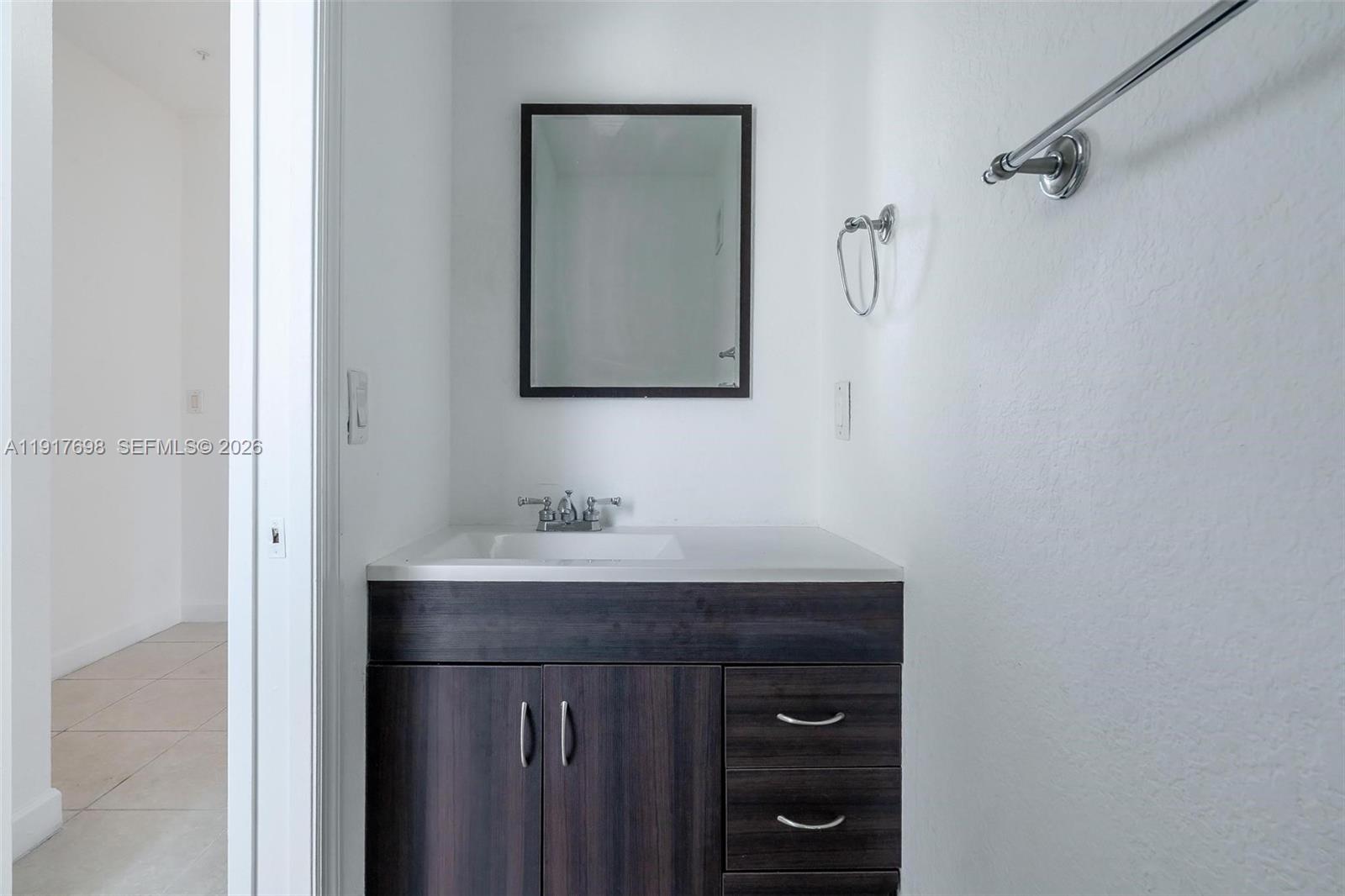 4371 Southwest 160th Avenue, Unit 211 Miramar, FL 33027 - Photo 8 of 31 a bathroom with a sink a vanity and a mirror