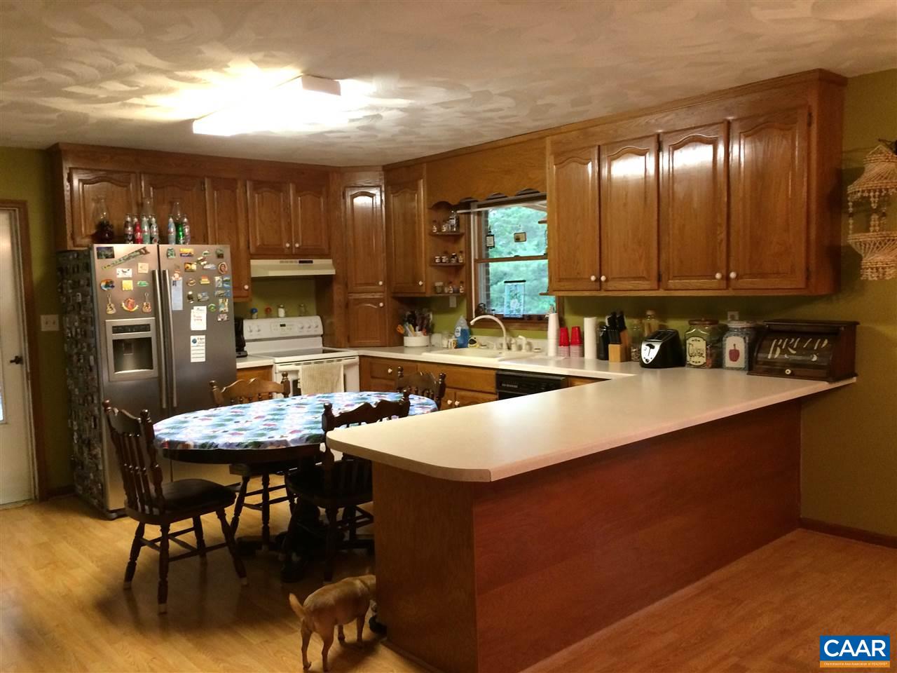 2351 Dunnes Shop Road Ruckersville, VA 22968 - Photo 7 of 8 a kitchen with stainless steel appliances granite countertop a table chairs sink and cabinets