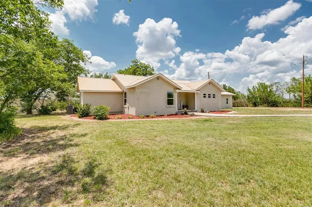 a view of a house with a yard and garage