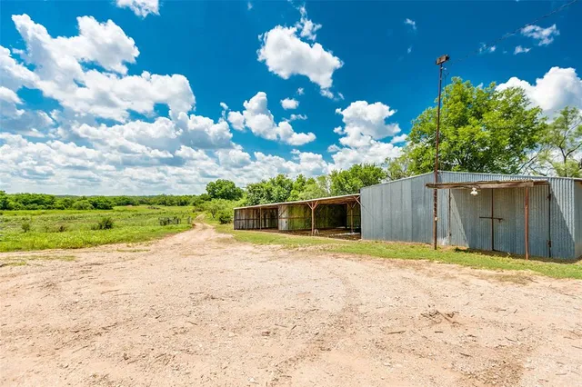a view of backyard with wooden fence