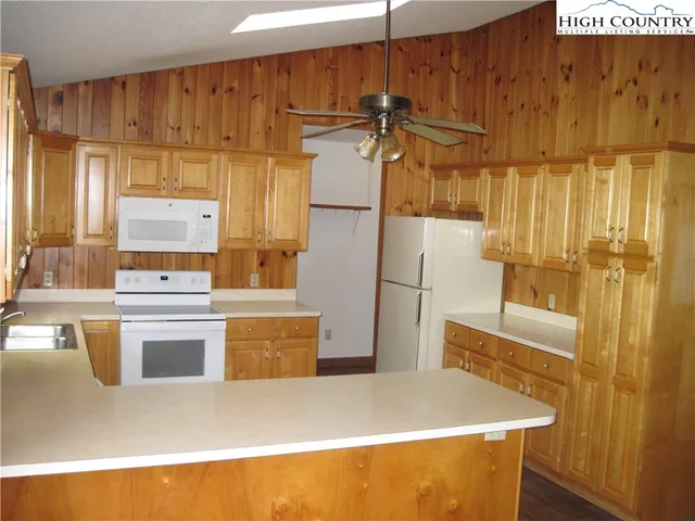 a kitchen with a refrigerator and a stove