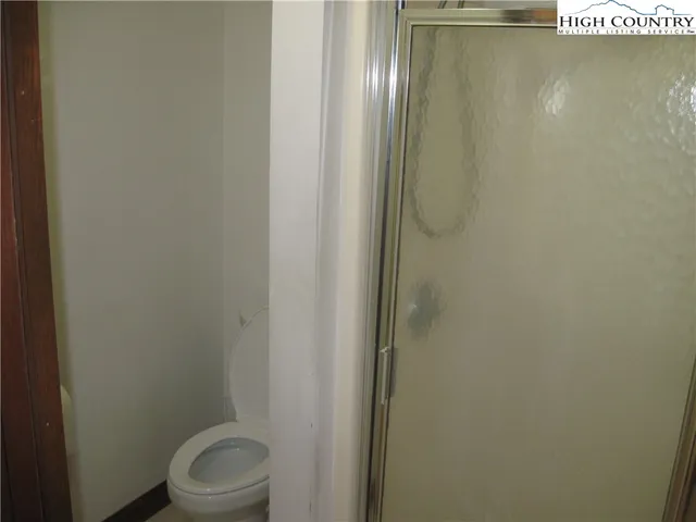 a bathroom with a white toilet and sink