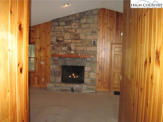 a view of an empty room with a fireplace