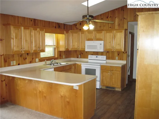 a view of a kitchen with a sink a microwave and refrigerator