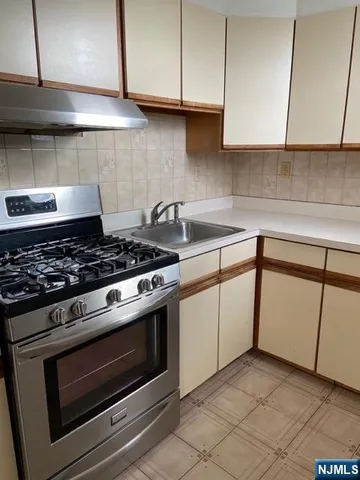 a kitchen with granite countertop cabinets and steel stainless steel appliances