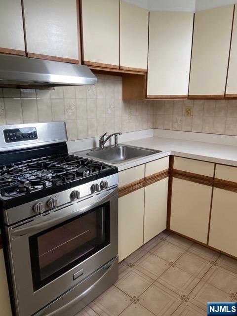 88 Shaler Avenue Fairview, NJ 07022 - Photo 17 of 22 a kitchen with granite countertop cabinets and steel stainless steel appliances