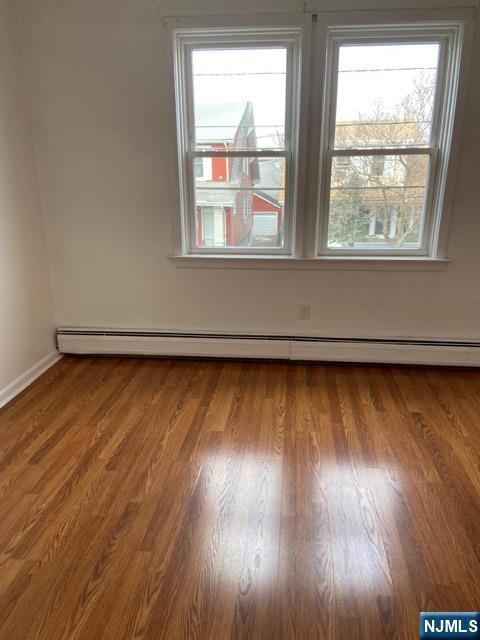 88 Shaler Avenue Fairview, NJ 07022 - Photo 18 of 22 an empty room with wooden floor and windows