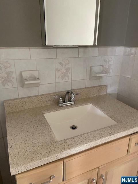 88 Shaler Avenue Fairview, NJ 07022 - Photo 21 of 22 a bathroom with sink and mirror