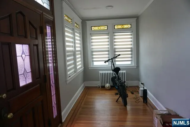 a view of a room with a window and wooden floor