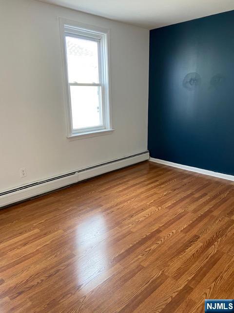 88 Shaler Avenue Fairview, NJ 07022 - Photo 7 of 22 an empty room with wooden floor and windows