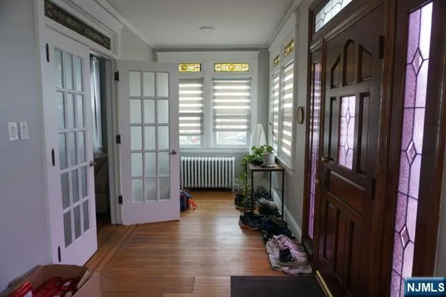 a hallway with a couch and a large window
