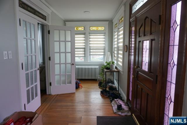 88 Shaler Avenue Fairview, NJ 07022 - Photo 8 of 22 a hallway with a couch and a large window