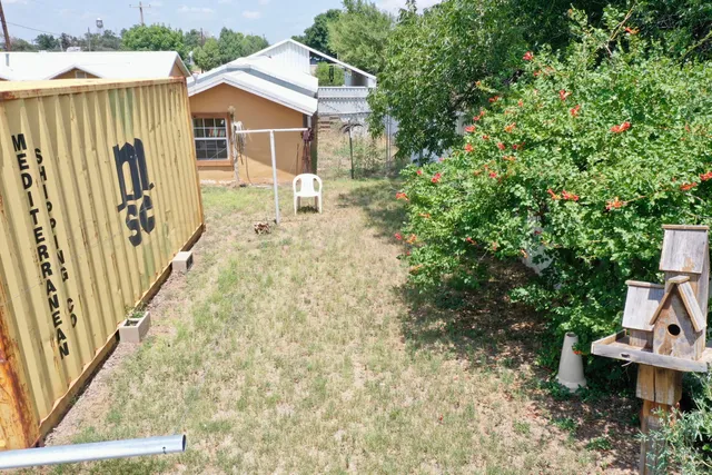 a view of a house with backyard and sitting area