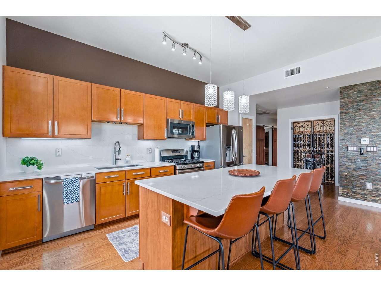 204 Maple Street, Unit 401 Fort Collins, CO 80521 - Photo 23 of 47 a open kitchen with stainless steel appliances kitchen island granite countertop a sink and cabinets
