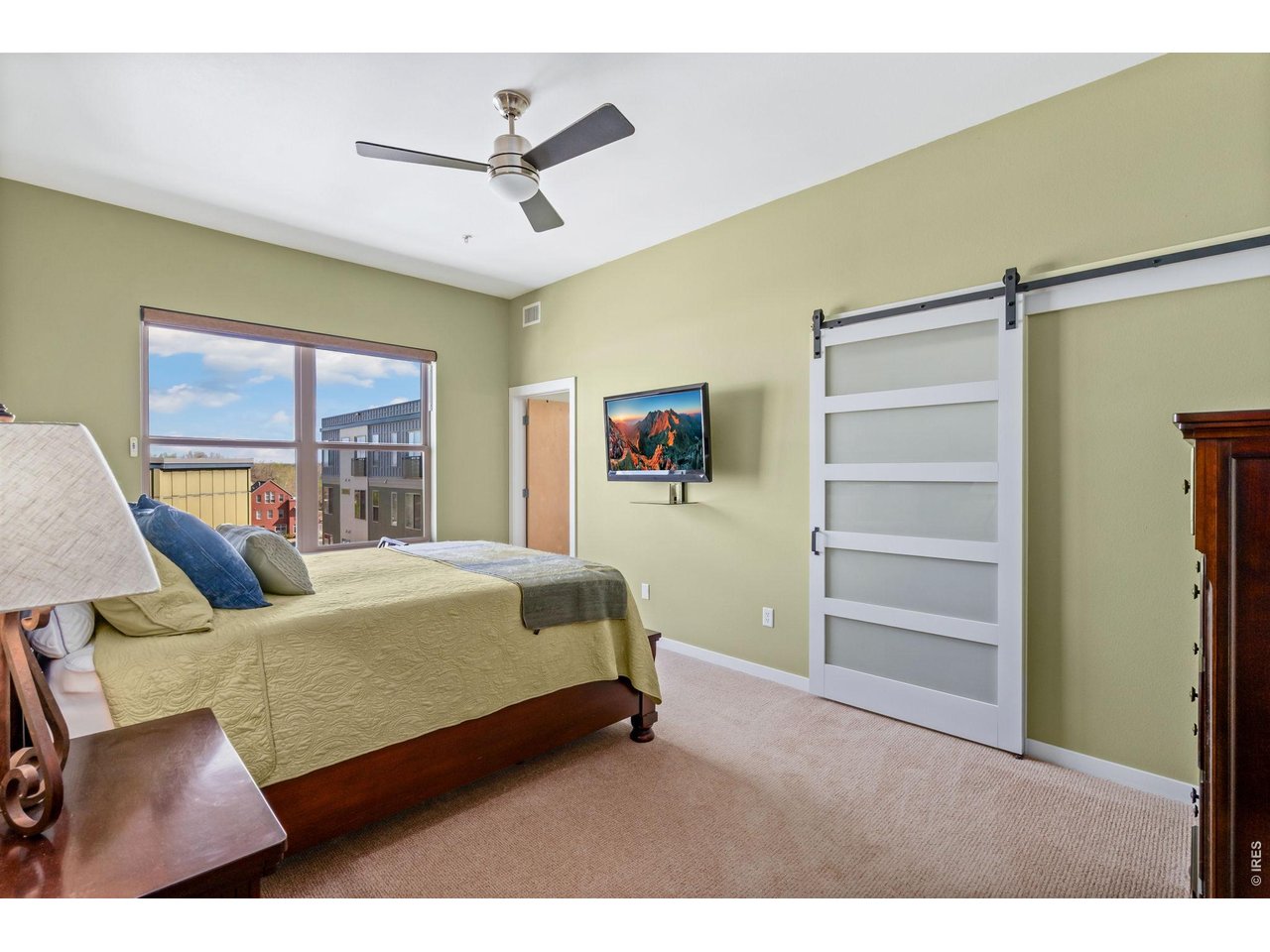 204 Maple Street, Unit 401 Fort Collins, CO 80521 - Photo 29 of 47 a bedroom with a bed and a ceiling fan