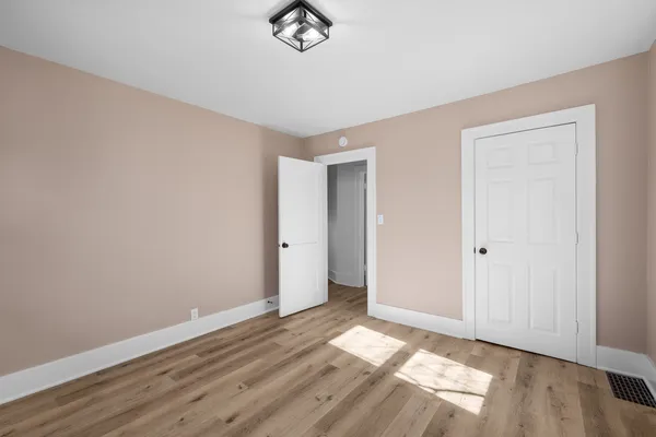 a view of a room with wooden floor and closet