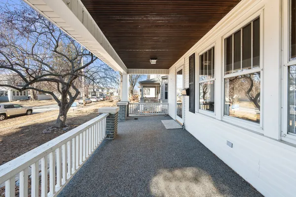 a view of a porch with wooden floor and fence