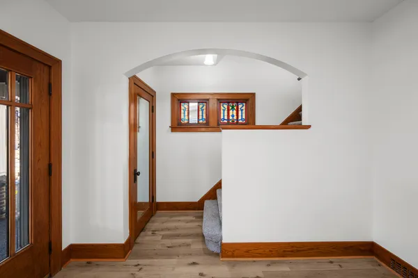 a view of a hallway with wooden floor