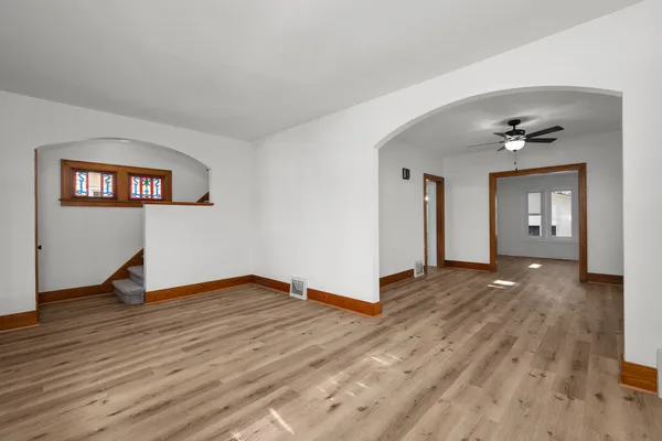 a view of a livingroom with wooden floor and a staircase