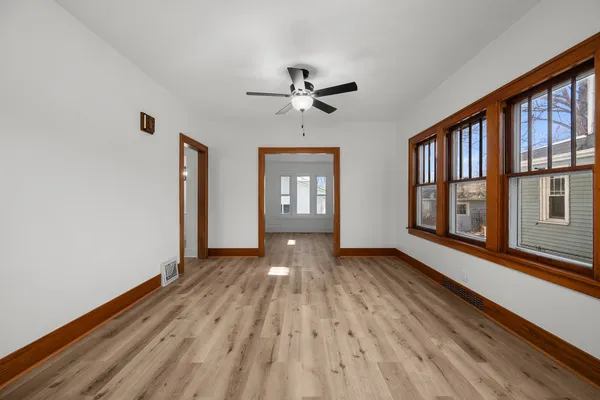 wooden floor in an empty room with a window