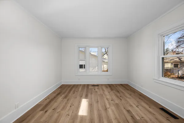 wooden floor in an empty room with a window