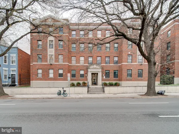 a view of a building with a yard