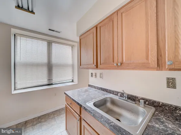 a kitchen with a stove a sink and a refrigerator