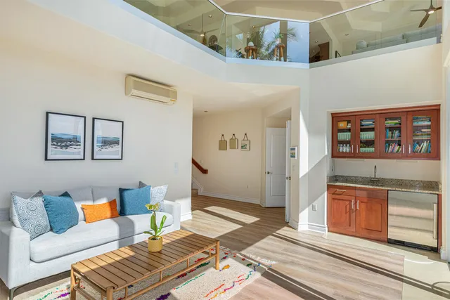 a living room with furniture and painting on the wall