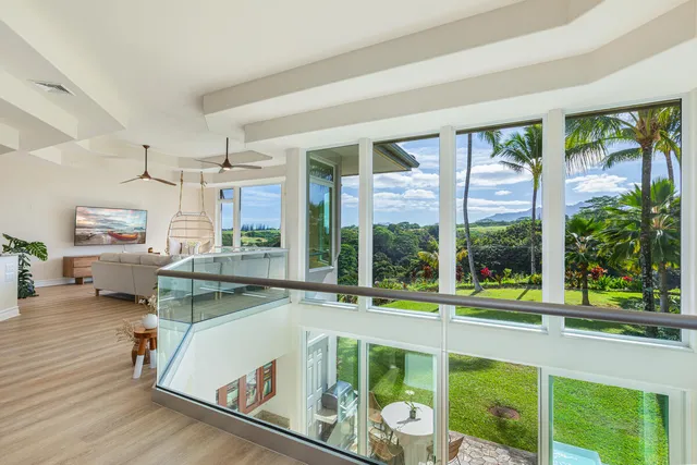 a living room with a large window and a table